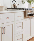 Brushed Antique Copper Kitchen Cabinet Pulls And Knobs Set, 5 Inch, installed on white cabinets in modern kitchen