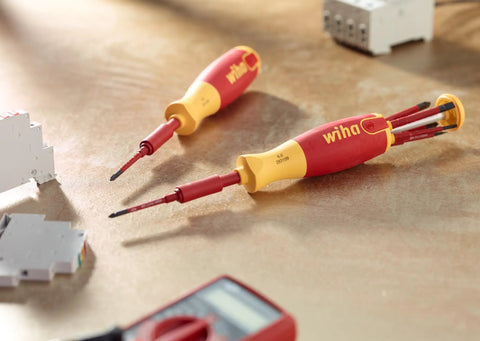 Insulated SlimLine Ultra Driver Blade Set with Slotted and Phillips Bits, 7 Piece Kit on workbench, close-up view.