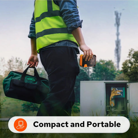 Person in reflective vest holding Job Site Tough Portable Industrial Label Printer With 1 Inch Print Head walking outdoors.