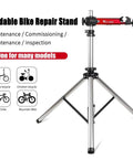 Bike Repair Stand with 360 Degree Swivel Clamp Adjustable Foldable Work Stand Lightweight Aluminum Floor Station 85 Lbs Max Capacity Tripod Base Quick Release Perfect For DIY Home Mechanics, showing tripod base and clamp.