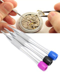 Color Coded Triangular Bit Set For 3235 Watch Movements with stainless steel bits and ergonomic handles shown next to a watch repair scene