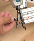 Close-up of a hand adjusting the tool-less jam clearing mechanism on the Rock Solid 18 Gauge 2 Inch Brad Nailer Kit.