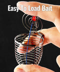 Close-up of Pro Grade Stainless Steel Bait Cage Ten Pack For Carp And Catfish Fishing held between fingers, open lid showing bait loading