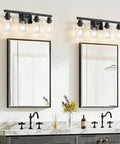 Top Shelf 4 Light Bathroom Vanity Light With Clear Glass Sleeves Matte Black Vintage Wall Sconce above modern gray sink and mirrors.