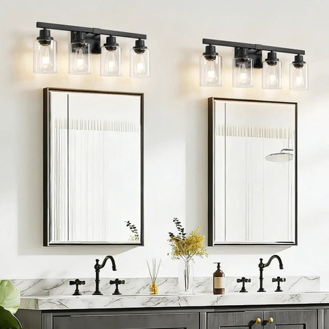 Top Shelf 4 Light Bathroom Vanity Light With Clear Glass Sleeves Matte Black Vintage Wall Sconce above modern gray sink and mirrors.