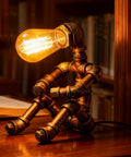 Dope Steampunk Table Lamp With Vintage Industrial Metal Robot Design on a wooden desk