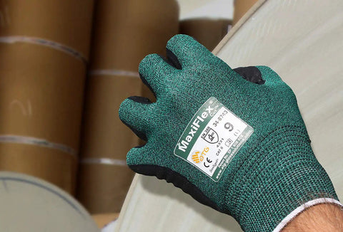 Hand wearing 34-8743 Cut Resistant Nitrile Coated Work Gloves For Tough Jobs Reusable Eco Friendly Hand Protection gripping material.