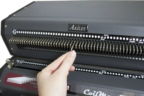 Hand using All-In-One Electric Coil Binding Machine with Punch, Inserter and Crimper - 54 Pin, 4:1 Pitch, 13 Inch, in action