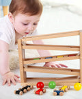 Toddler playing with Wooden Race Track Ramp Toy For Toddlers 5 Level Car Ramp Set With 4 Wood Cars And 3 Balls, no assembly