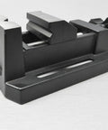 Compact Table Vise For Bench And Drill Press, Mini Precision Vise For Jewelry Hobbyists, Zinc Die Cast Construction, Grips Small Parts With Horizontal And Vertical V Grooves, Mounting Slots With Bolts Washers And Wing Nuts Included. black mini vise side view with base slot