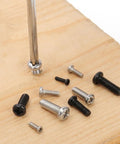 Top Shelf Assorted Metric Micro Screw Kit Packing 1200 Phillips Pan Head Fasteners Across Twenty Four Precision Sizes scattered on wood.