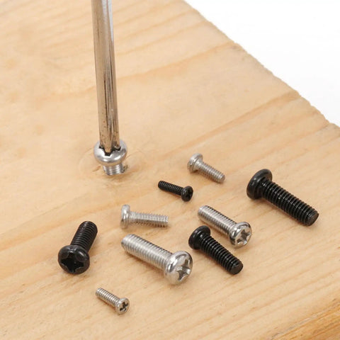 Top Shelf Assorted Metric Micro Screw Kit Packing 1200 Phillips Pan Head Fasteners Across Twenty Four Precision Sizes scattered on wood.