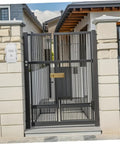 Ultimate Outdoor Waterproof Electrical Junction Box For Surveillance And Electronic Gear Durable Plastic Enclosure With Easy Install For Any Home Setup Or Job Site outside entrance gate with black metal bars and stone columns.