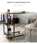 C Shaped Bedside Table With Heavy Duty Wheels And Locks Height Adjustable Laptop Workstation with books and drink.
