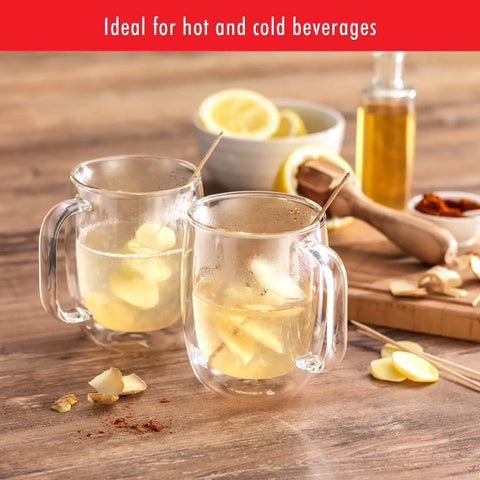 Four Piece Double Wall Insulated Glass Coffee Mug Set Keeps Hot Brews Steaming And Icy Drinks Frosty With Zero Sweat Marks Premium Borosilicate Glass Is Dishwasher Safe For Your Daily Grind Routine showing two mugs with herbal tea and lemon.