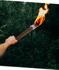 Outdoor Solar Tiki Torch Light For Garden Fence Decoration With Woven Wood Look Weatherproof And Easy Install Eco Friendly Yard Pathway Lantern Hanging Decor For Patio Trees Wedding And Landscape Lighting being held in a wooded area.