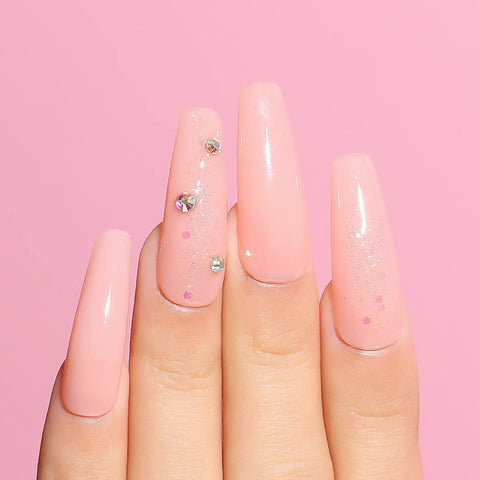 Hand with glossy, pink nails enhanced by the HEMA Free Rubber Base Gel Kit For Nails Soak Off UV LED Clear Sheer Gel Polish.