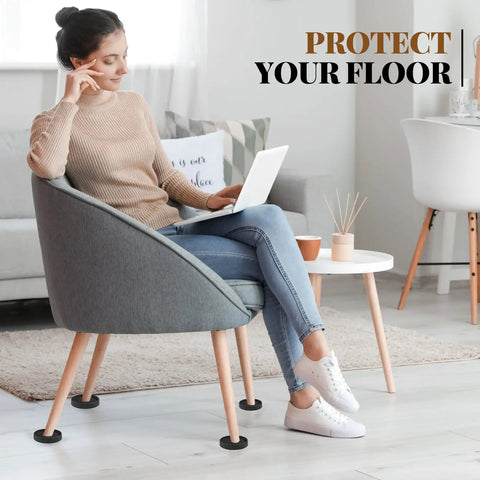 Four Pack Three Inch Round Rubber Furniture Caster Cups Delivering Real Floor Defense with cushioning under a chair.