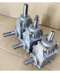 Heavy Duty T Shape Gearbox Boasting A Clean One To One Transfer Ratio For Snappy Ninety Degree Right Angle Steering On Any Everyday Mechanical Setup Or Garage Upgrade, showing three gearboxes on cardboard.