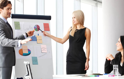 Professionals discussing charts with Lined Sticky Notes 4x6 Inches, 360 Sheets In 9 Packs, Vintage Colors for office presentations.
