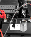 Close-up of Real Deal Pneumatic Paint Sprayer with tough metal housing on a car battery for high precision atomization.