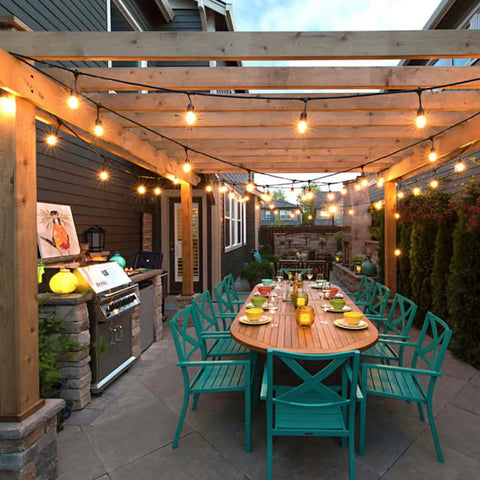 Warm White 50ft Low Voltage String Lights With 10 2W Bulbs 135 Lumens Each 2800K in outdoor patio setting over dining table