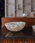 Top Shelf Natural Agate Stone Sink For Bathroom And Kitchen Round Semi Precious Spa Wash Basin With Hardened Glaze Straight Up Luxury Vanity Bowl With Slick Finish on a dark countertop.