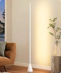 Modern minimalist floor lamp in cozy living room corner, next to a plant and brown chair.