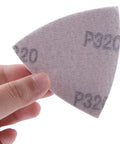 Hand holding a P320 Triangle Sanding Pads Set For 3-1/8 Inch Oscillating Multi Tools, 100 pcs, hook and loop, no holes, 80x80x80mm pad for finishes.