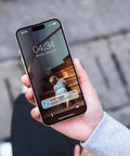 Person holding smartphone displaying a camera alert with a toddler on stairs, illustrating motion alerts feature in smartphones.