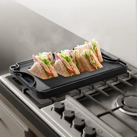 Reversible Cast Iron Grill And Griddle Pan Fourteen By Eight And A Half Inch Preseasoned Portable with sandwiches on stovetop