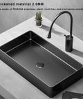 Modern Black 304 Stainless Steel Countertop Bathroom Sink Paired With Streamlined Faucet, thick black basin and sleek faucet on a countertop.