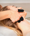 100 Pack Black Silicone Finger Cots And Protective Toppers For Manicures And Massage Sessions Soft Disposable Fingertip Shields in use during a massage.