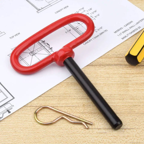 Built Tough Heavy Duty Trailer Hitch Pin With Vibrant Red Handle And Secure Safety Clip Precision Clevis Towing Pin on wood surface.