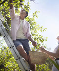 Man and woman picking fruit using ladder with Replacement Shoe Kit For Aluminum Extension Ladders Grippy Non Slip Feet.