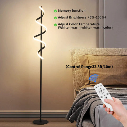Tall Black Spiral Torchiere Floor Lamp With Remote Dimming And Color Changing LED next to a bed, remote being used