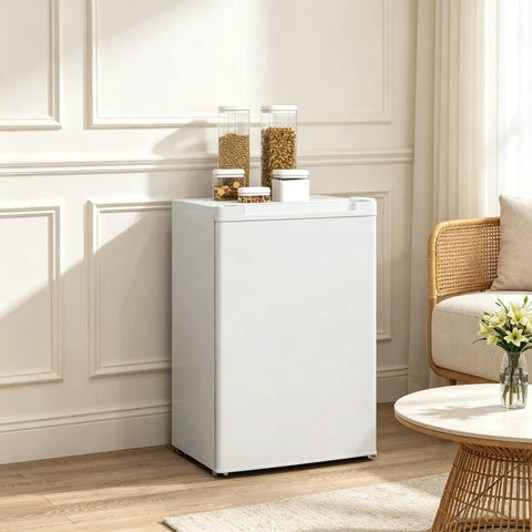 3 Cu Ft Compact Upright Freezer With Reversible Door And Bright White Shell in a modern living room setting.