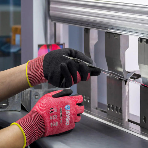 Cut Resistant Nitrile Coated Safety Gloves With Firm Grip ANSI Cut A4 KG22N Ideal For Construction Warehouse Woodworking And DIY Projects Durable Work Gloves For Heavy Duty Handling shown in metalworking environment.