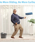 Man joyfully mopping on a rug using Eight Pack Rug Tape Grippers For Rugs Reusable Washable Non Slip Double Sided Rug Pads