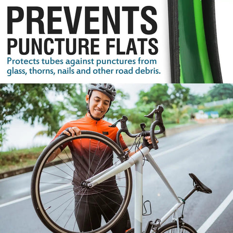 Cyclist holding a bike with a Bike Tire Liner That Prevents Flats And Punctures With A Tough TPU Shield For 24 To 29 Inch Mountain And Road Tires.