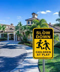 Slow Down Sign for Kids at Play 2 Pack Aluminum Safety Caution Signs for Street Yard and Neighborhoods 18 by 12 Inches Black and Yellow Reflective UV Coated Outdoor Signs installed by road