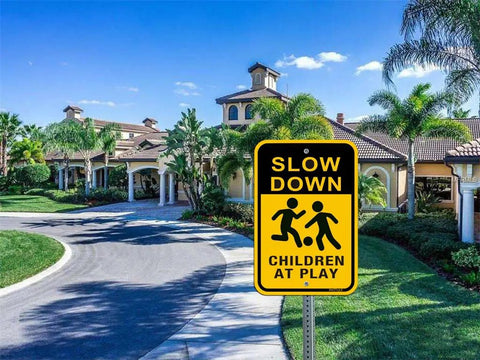 Slow Down Sign for Kids at Play 2 Pack Aluminum Safety Caution Signs for Street Yard and Neighborhoods 18 by 12 Inches Black and Yellow Reflective UV Coated Outdoor Signs installed by road