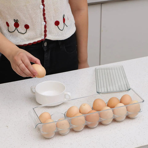 Person using Clear 14 Egg Organizer Tray For Refrigerator Narrow Stackable Dispenser No Brainer Easy Access and Space Saving BPA Free Plastic