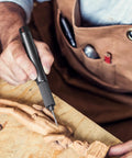 Person using USB Rechargeable Electric Engraving Pen With 24 Bits Cordless Rotary Engraver for detailed wood carving