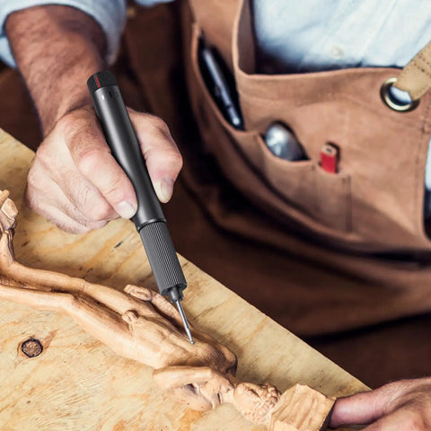 Person using USB Rechargeable Electric Engraving Pen With 24 Bits Cordless Rotary Engraver for detailed wood carving