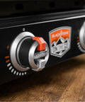Close-up of control knobs on 22-Inch Tabletop Griddle with Built-In Hood for Camping and Tailgating, featuring dual heat zones.