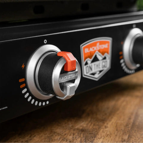 Close-up of control knobs on 22-Inch Tabletop Griddle with Built-In Hood for Camping and Tailgating, featuring dual heat zones.