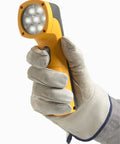 Rock Solid LED Stroboscope Featuring 30 To 300000 FPM Flash Rate And Knockout Brightness held in a gloved hand for inspection.