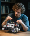 Person assembling Realistic V8 Engine Model Kit With Working Pistons Lights And Motor Visible Engine Movement STEM Build Set