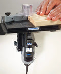 Bench Mounted Router Table Adapter For Corded Rotary Power Tools Featuring Six Hardened Steel Shaping Bits in use with wood.